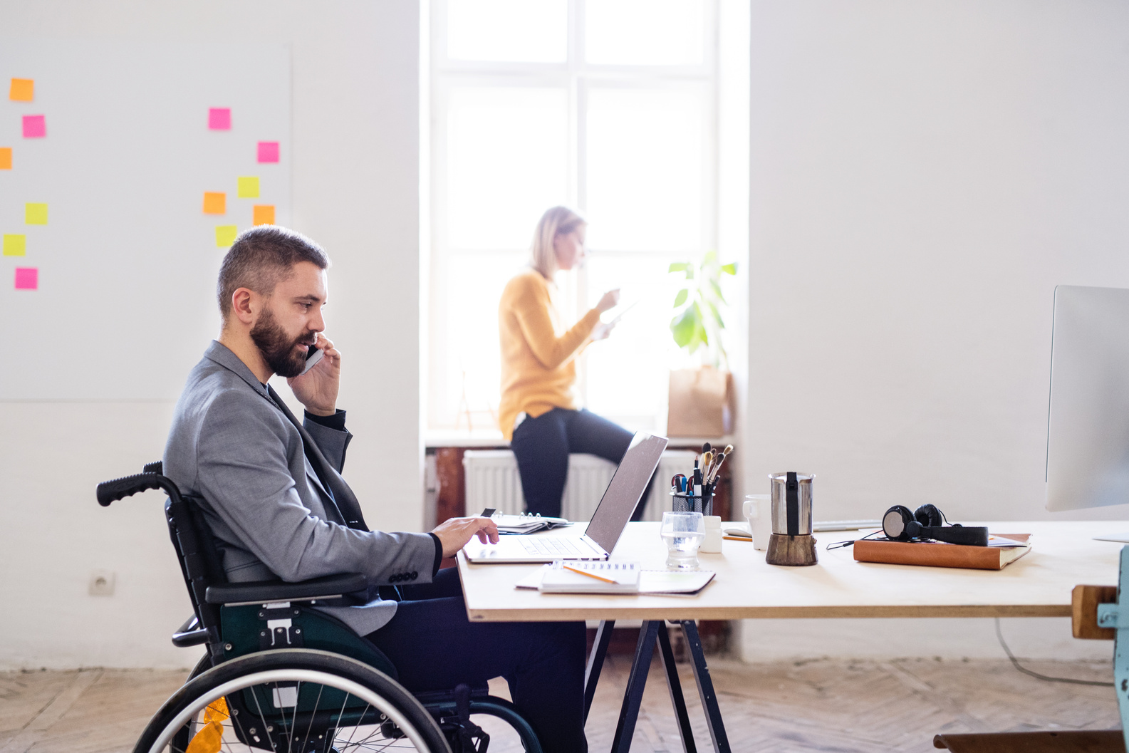 Two Business People with Wheelchair in the Office